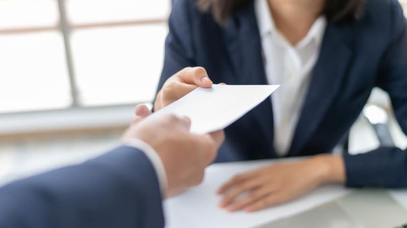 Person handing check to another person