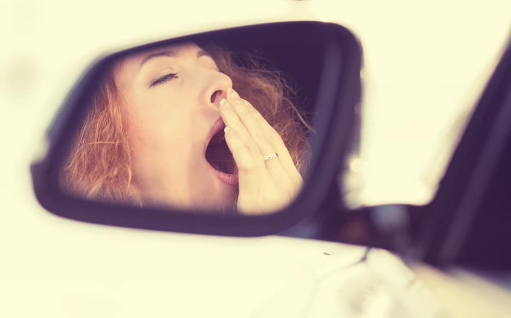 Woman yawning in car