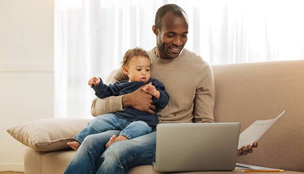 Man and baby home on couch
