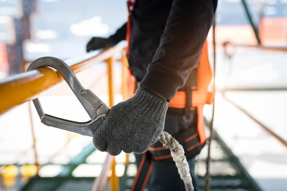 Construction worker clipping to railing