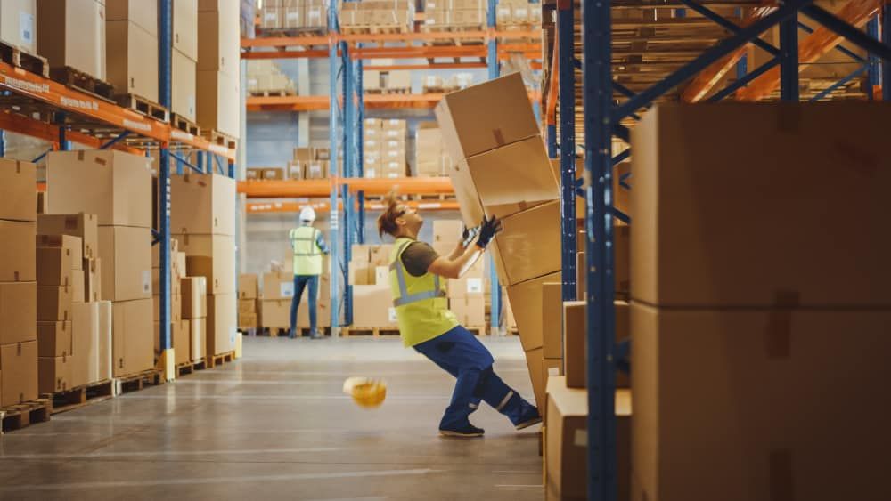 Worker in warehouse falling